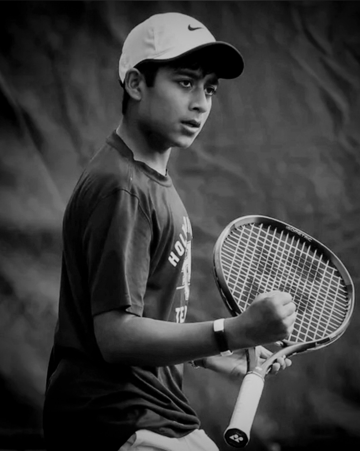 Shaan in his Holy Trinity shirt and cap, clenching his fist after winning a point